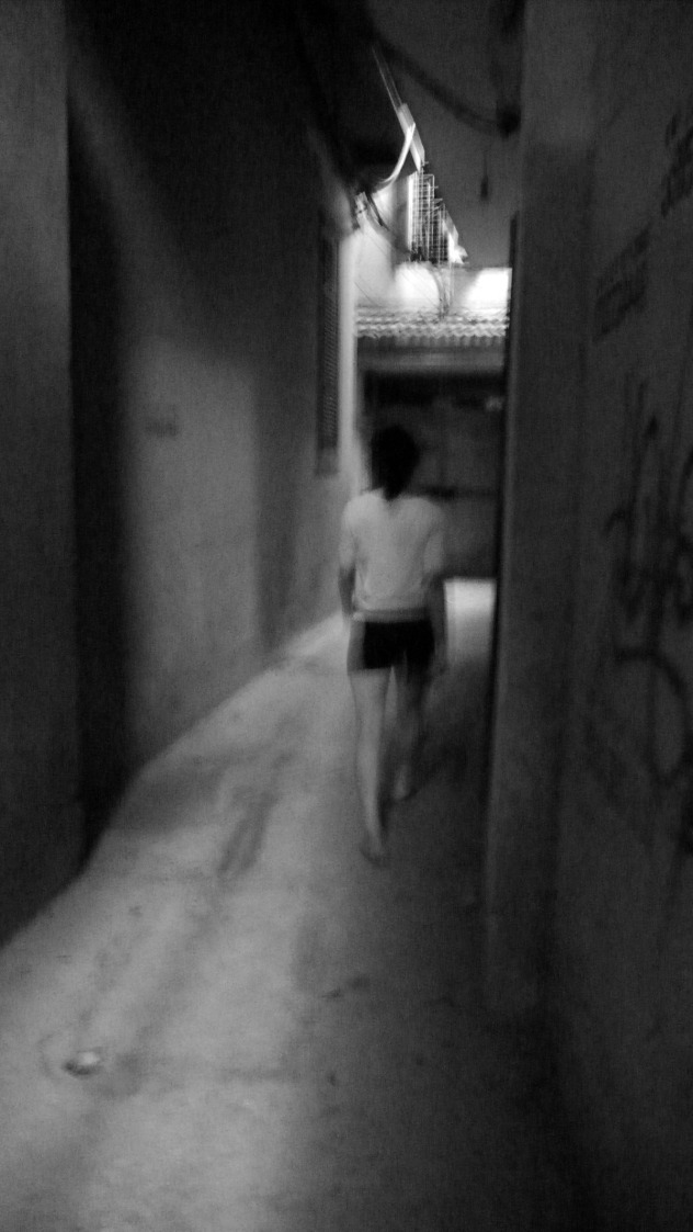 woman shadow walks alley.jpg