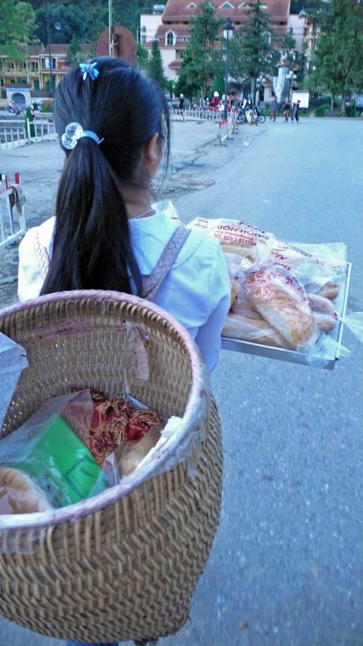 girls carries sells bread.jpg