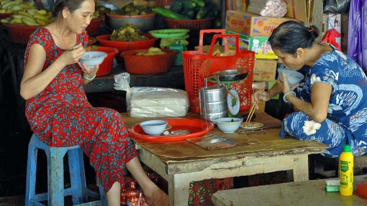 two women eating fish market.jpg